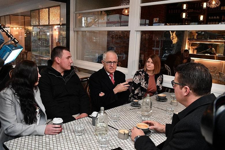 Australian Prime Minister Malcolm Turnbull visiting a cafe in Canberra to speak on his government's income tax cuts last month. His personal popularity is at its highest level in two years, according to the latest opinion poll.