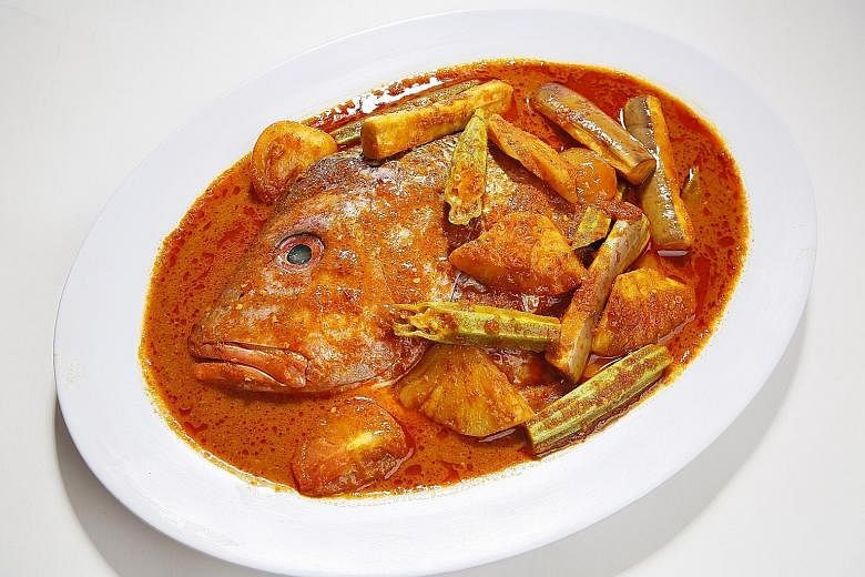 The signature assam fish head that comes with a spicy and sour assam-blend gravy is one of Gu Ma Jia's most popular dishes.