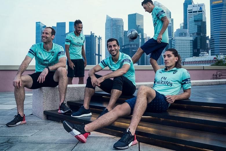 From left: Petr Cech, Pierre-Emerick Aubameyang, Henrikh Mkhitaryan, Mesut Ozil and Hector Bellerin model Arsenal’s third kit under Singapore’s central business district skyline. The Gunners face French champions Paris Saint-Germain tonight at the Nationa