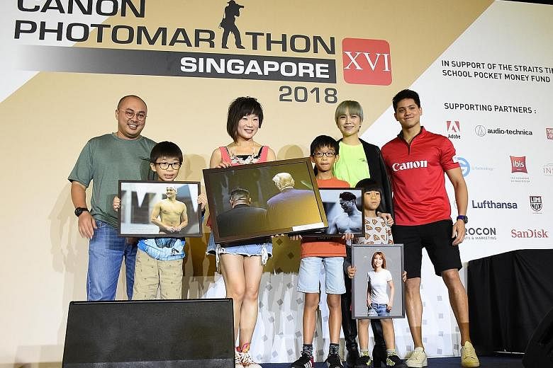 Civil servant Tangie Kay, 42, and her children (from far left) Kenji, nine, Junya, 11, and Nori, seven, holding photos that were bought by Ms Kay's friend as part of the fund-raising efforts. With them are (from far left) Mr Norman Ayob of Canon Sing
