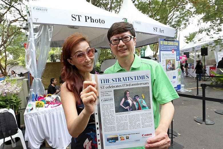 Left: The Singapore Symphony Orchestra playing to a packed audience at the Shaw Foundation Symphony Stage yesterday. Above: Ms Elaine Huang, 50, and Mr Hwang Hong Wei, 51, with their mock-up of a Straits Times front page, featuring a photo of them ta