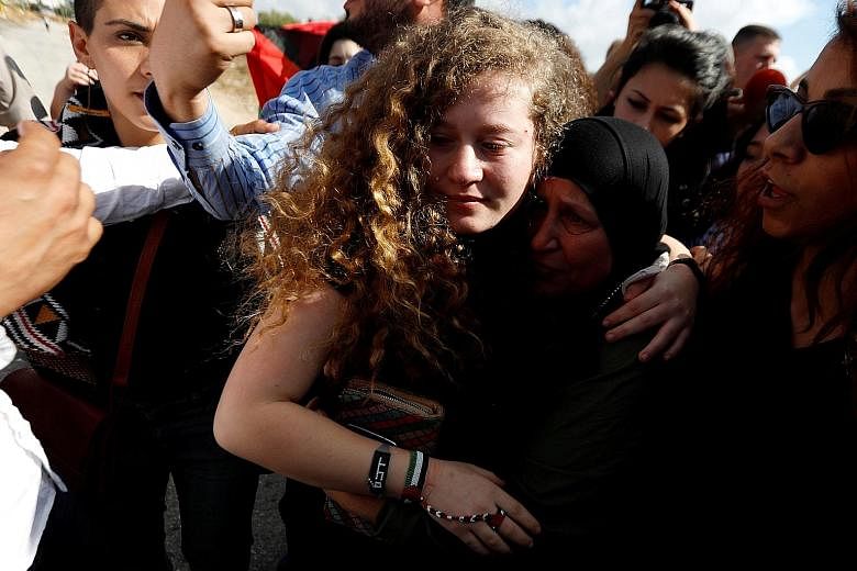 Relatives and supporters welcome Palestinian teenager Ahed Tamimi after her release from an Israeli prison, at Nabi Saleh village in the occupied West Bank. She was sentenced to eight months' imprisonment for kicking and slapping an Israeli soldier o