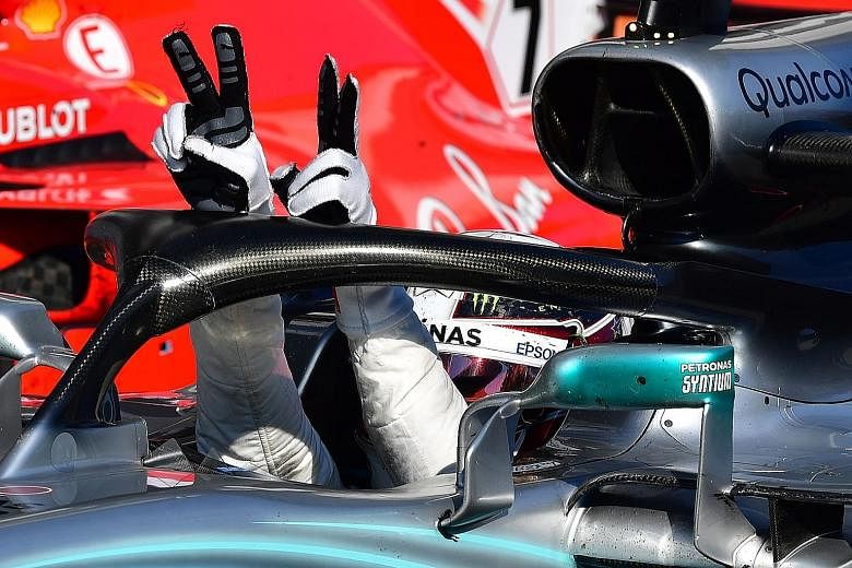 Mercedes driver Lewis Hamilton flashes the V-for-victory sign after winning the Hungarian Grand Prix yesterday. Ferrari duo Sebastian Vettel and Kimi Raikkonen were second and third respectively.