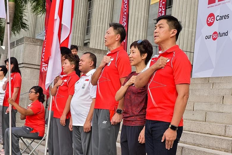 From left: Swimmer and pledge-taker Amanda Lim, para-archer Nur Syahidah Alim, paddler Koen Pang (blocked by flag), chef de mission for Youth Olympic Games Tao Li, chef de mission for Asian Para Games Ali Daud, chef de mission for Asian Games Lee Wun