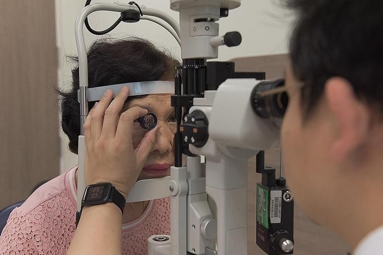 Singapore National Eye Centre consultant Gavin Tan doing a mock eye check (above) and eye injection with Madam Kueh Jee Kim. There has been a shift away from laser treatment to drugs injected into the eye to treat vision loss caused by diabetic retinopath