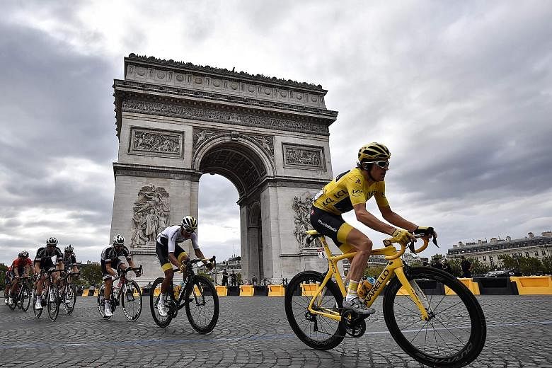 Geraint Thomas, wearing the leader's yellow jersey, riding past the Arc de Triomphe on the last stage of the Tour de France on Sunday. The 32-year-old, dogged by bad luck on several previous Tours, won the classic race on his ninth attempt.