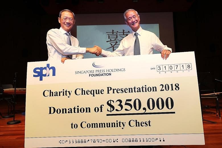 SPH and SPH Foundation chairman Lee Boon Yang presenting the cheque to Community Chest vice-chairman Eric Ang (far right), who received it on behalf of the social service organisations.