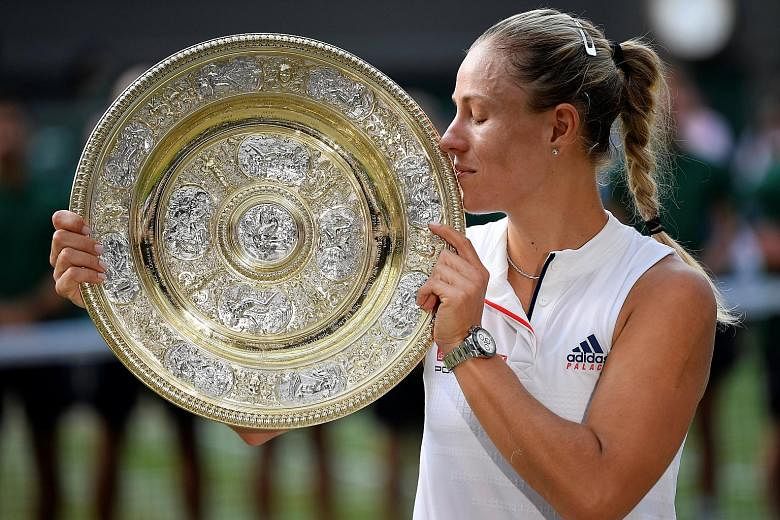 Angelique Kerber getting acquainted with the Venus Rosewater Dish, her prize for winning Wimbledon after overcoming Serena Williams in the final.