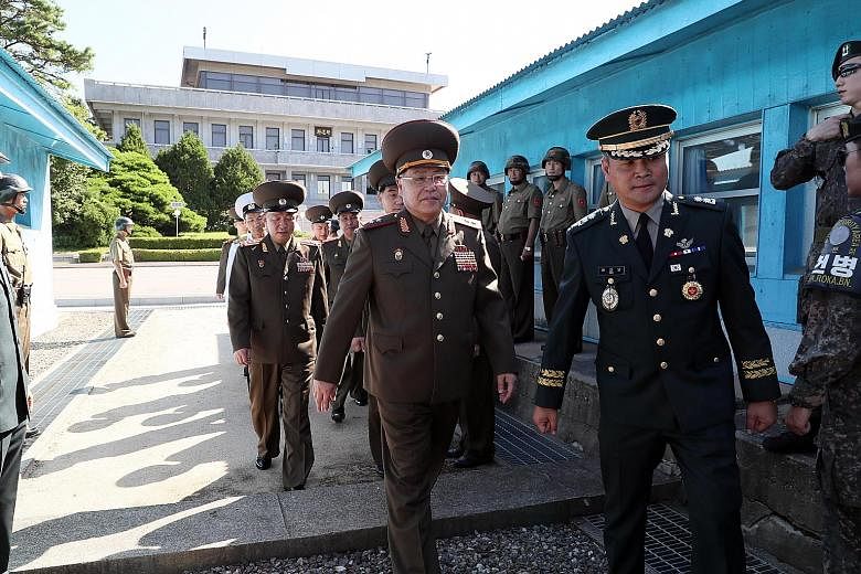 North Korea's Lieutenant-General An Ik San (right, wearing glasses) heading for the Peace House in the border truce village of Panmunjom in the South for the meeting with his South Korean counterpart yesterday. The talks produced no joint statement -
