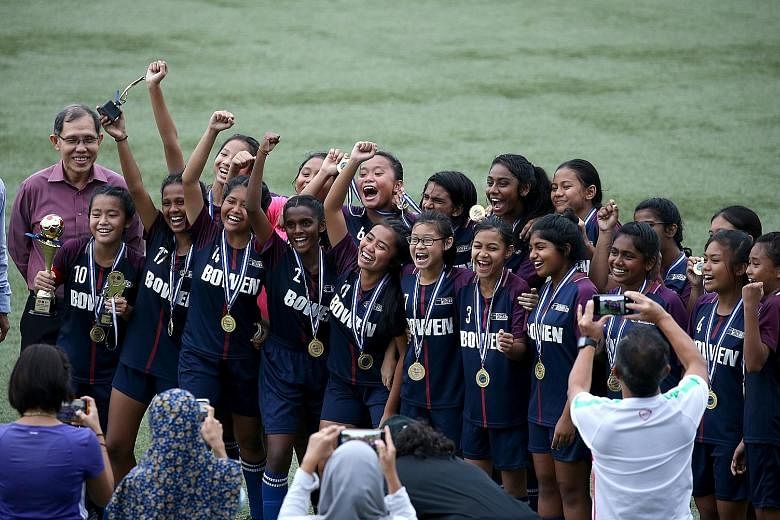 Bowen Secondary celebrating their 1-0 victory over rivals Queensway Secondary in the Schools National C Division girls' football final at the Singapore University of Technology and Design stadium yesterday. Nurhidayu Naszri scored the winning goal as