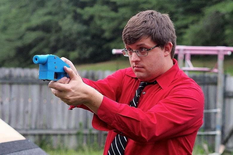 Photos taken in 2013 of software engineer Travis Lerol with a Liberator gun, and the 3D printer (above) which made its components.