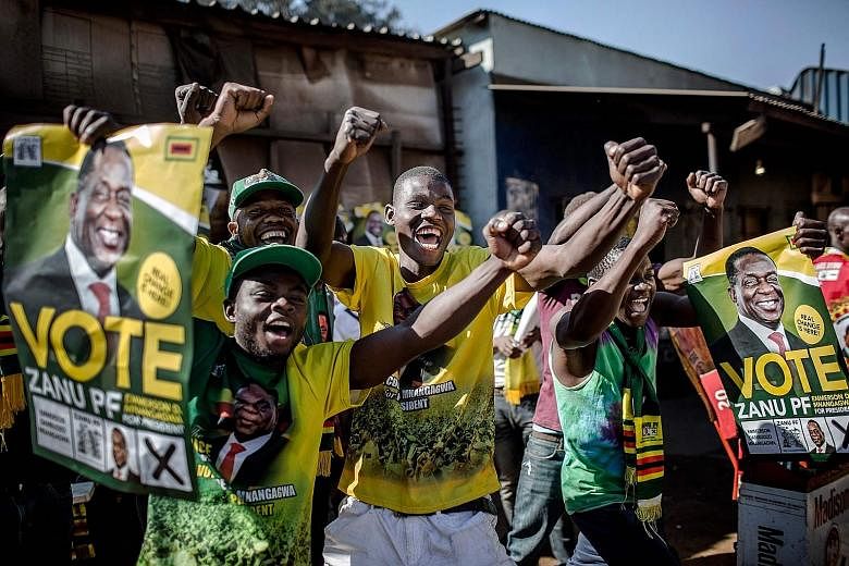Supporters celebrating yesterday in the suburb of Mbare of Zimbabwe's capital Harare after President Emmerson Mnangagwa is declared the winner in the country's landmark election with 50.8 per cent of the vote. His main rival Nelson Chamisa won 44.3 p