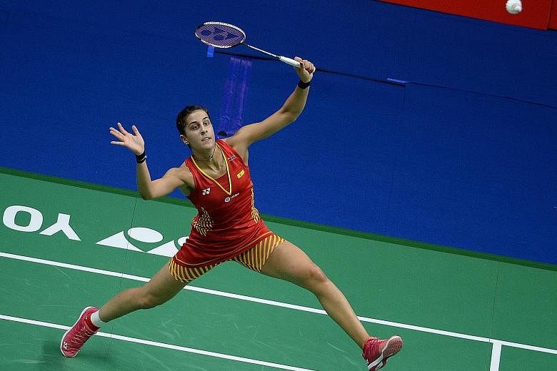 Spain's Carolina Marin making a return to India's Saina Nehwal in the women's singles quarter-finals at the World Championships in Nanjing, China, yesterday. The 25-year-old Spaniard trounced Nehwal 21-6, 21-11.