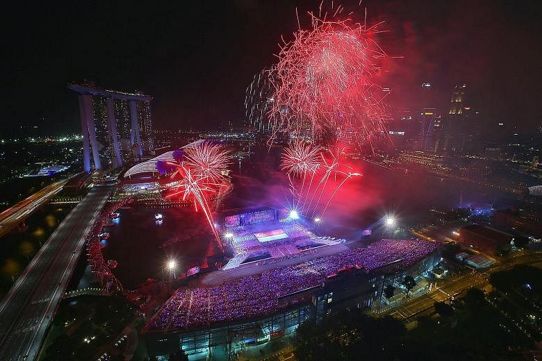 Top and above: During the NDP Preview on Sunday, fireworks lit the sky in the daytime and at night. Right: Workers preparing fireworks for an NDP rehearsal.