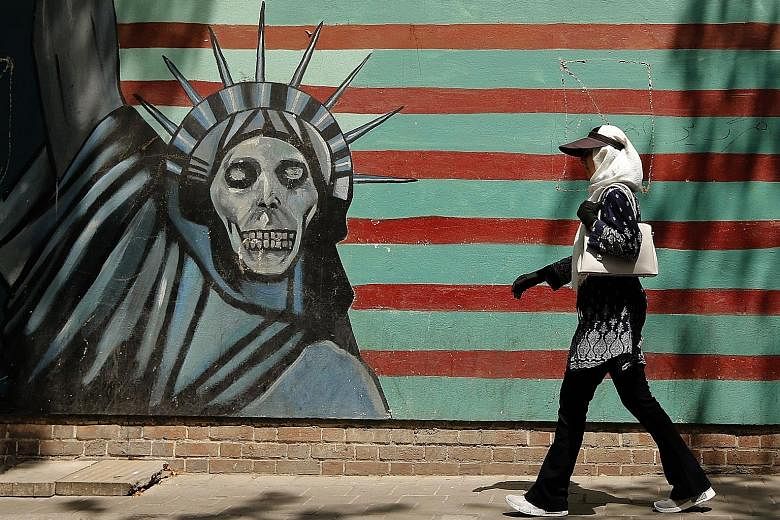 A mural on the wall of the former United States embassy in Teheran. The American sanctions target Iran's access to US dollars.