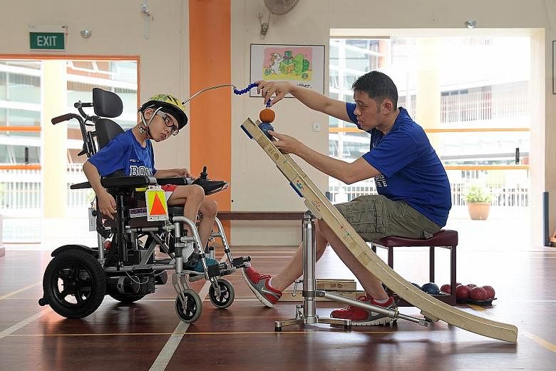 Kagan Gan, as ramp assistant, helping his son Aloysius in a game of boccia where Aloysius has to plan the strategy in double quick time and signal his father to set up the ramp accordingly before he propels the ball.