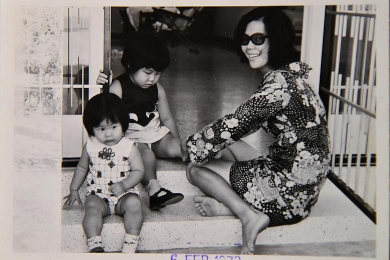 Left: Madam Lee Siew Eng, one of the oldest active Great Eastern Life insurance agents, has been selling insurance for 45 years. Below left: Madam Lee in a February 1973 photo with her daughters Alice (left) and Grace. Below: Madam Lee also chaired t