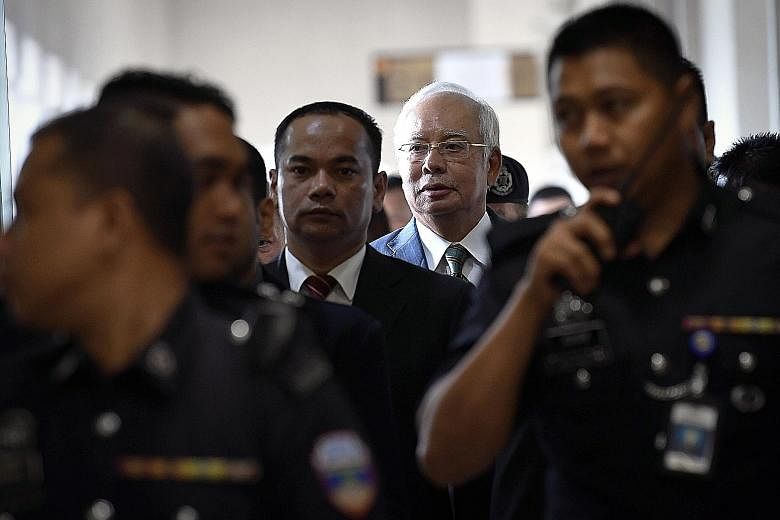 Former Malaysian prime minister Najib Razak, who now has seven criminal charges against him, leaving the Jalan Duta court complex in Kuala Lumpur yesterday.