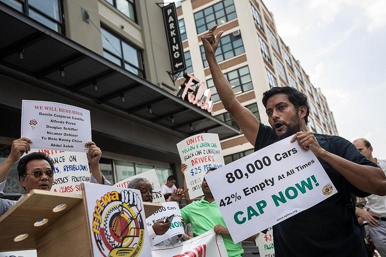 For-hire drivers and their supporters rallying in favour of proposed legislation that would put a cap on ride-hailing cars on Monday, outside the headquarters of the New York City Taxi and Limousine Commission, which also houses offices of Uber and L
