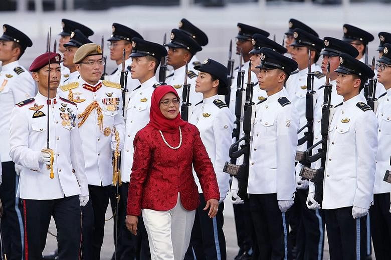President Halimah Yacob inspecting the Guard of Honour yesterday. It was her first NDP as President, but not the first time she had a formal NDP role. Before she became President, she was the reviewing officer at every parade preview since 2013 when 