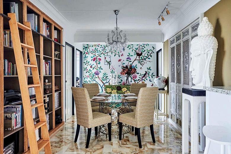 (Far left) Furniture with Oriental details, such as lacquer finishes, adorns the five-room flat. (Left) A freestanding claw-foot tub and handprinted floral mural create an old-world vibe in the bathroom. While the home owners have retained the marble