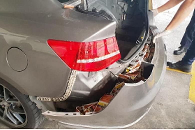 It seemed like tobacco was hidden in every part of the car - (from left) under the seats, in the rear bumper and even in the spare tyre - when Immigration and Checkpoints Authority (ICA) officers foiled a smuggling attempt at Woodlands Checkpoint on 
