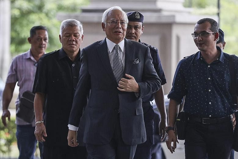 Former Malaysian prime minister Najib Razak arriving at the Kuala Lumpur High Court yesterday, where his application for a gag order on the media was dismissed. Responding to Umno's latest move, Najib said in a Facebook post that the party's new lead