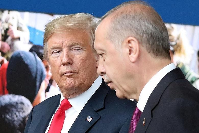 Turkish President Recep Tayyip Erdogan (right) has remained defiant in the face of pressure from US President Donald Trump.