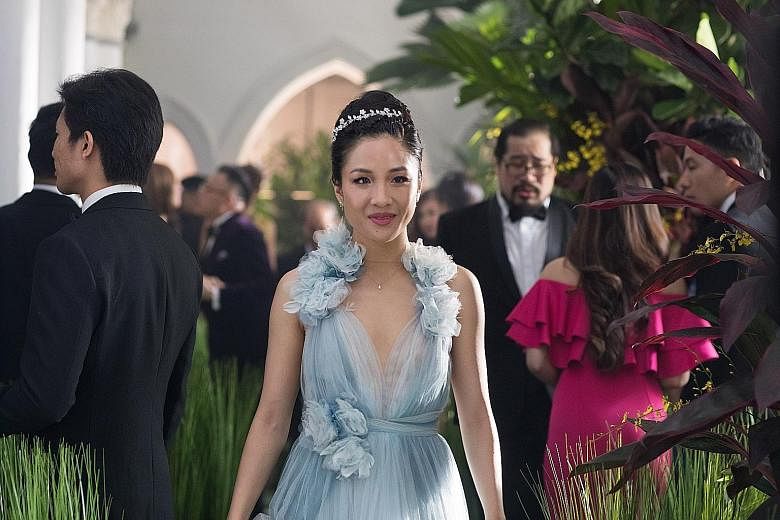 Constance Wu (left) is New Yorker Rachel Chu who accompanies her boyfriend Nick Young, played by Henry Golding, to his best friend's wedding in Singapore. Actress Michelle Yeoh (right, in beige gown) plays his disapproving mother who sets out to brea