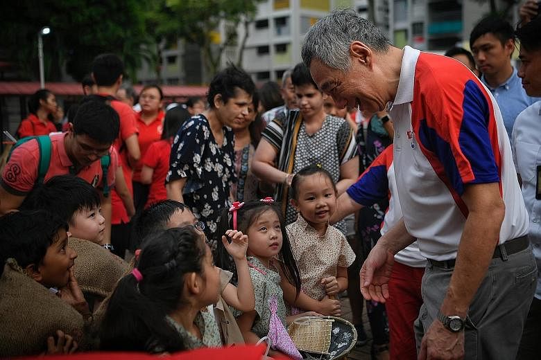 Prime Minister Lee Hsien Loong meeting PCF Sparkletots Preschool children who performed as samsui women during the National Day celebration in Ang Mo Kio Street 31 yesterday.