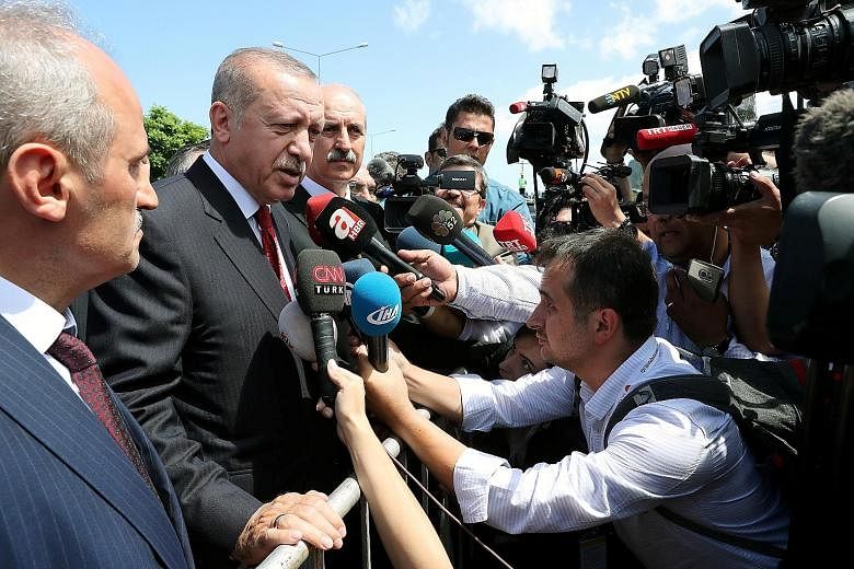 Turkish President Tayyip Erdogan talking to the media in the Black Sea city of Ordu yesterday. Mr Erdogan has repeated a call to Turks to help support the lira in what he calls a "war of independence". Turkey and the US are at odds over a wide range 