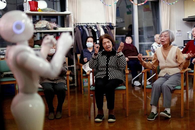 Senior citizens following moves made by humanoid robot Pepper during an exercise routine at Shin-tomi nursing home in Tokyo. The phrase hyakunen jinsei (100-year life) has bustled into Japan's corporate vocabulary; in some cases, such as manufacturin