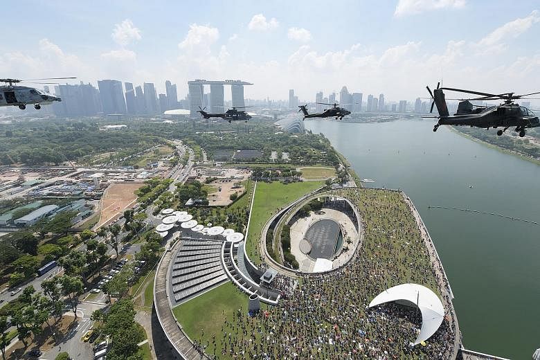 RSAF helicopters performing a fly-past witnessed by crowds at the Celebrating RSAF50 picnic at Marina Barrage yesterday. The formation consisted of a Chinook helicopter in the lead, followed by two Apaches, two Super Pumas, and a Seahawk.
