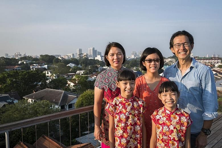 Mr Andrew Chew and his wife Jennifer Kiing (left) with their children - eldest daughter Elizabeth (centre) and twins Esther (foreground left) and Emma.