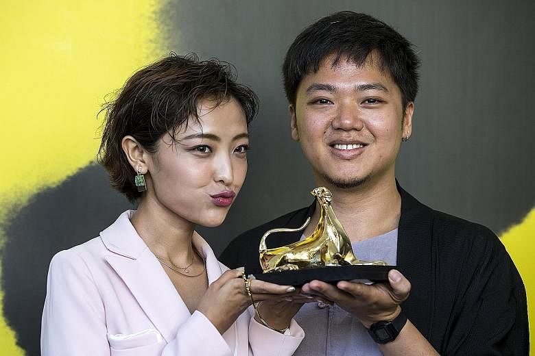 Chinese actress Luna Kwok and Mr Yeo Siew Hua with the Pardo d'Oro (Golden Leopard) which he won yesterday for his film A Land Imagined.