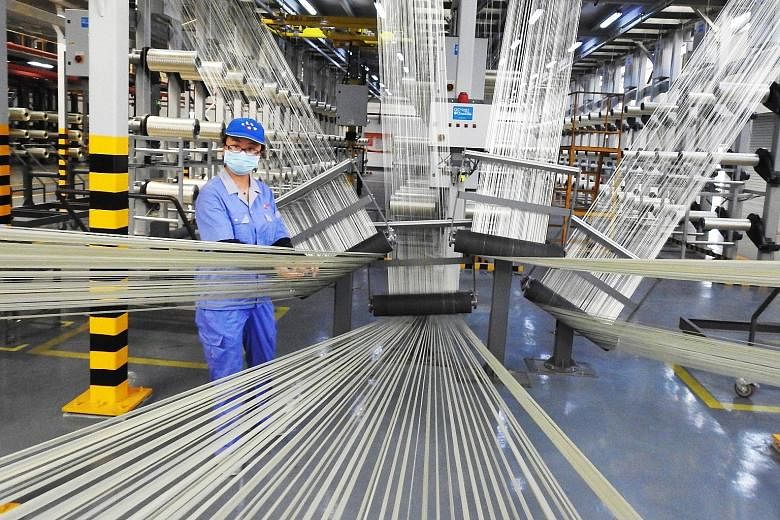 An employee works on a carbon fibre production line in Lianyungang in China's eastern Jiangsu province. The week will likely be another one of watching economic indicators while the influence of geopolitics on markets remain commonplace, says Ms Pan 