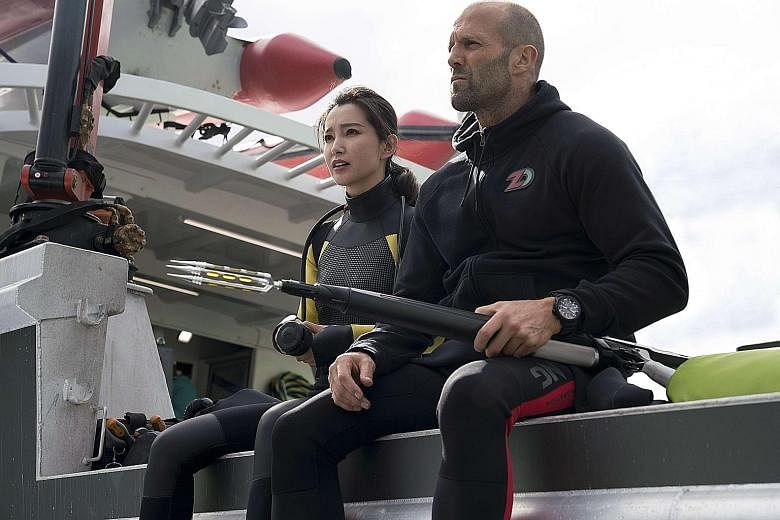 Rescue diver Jonas (Jason Statham) and scientist Suyin (Li Bingbing, both right) in The Meg.