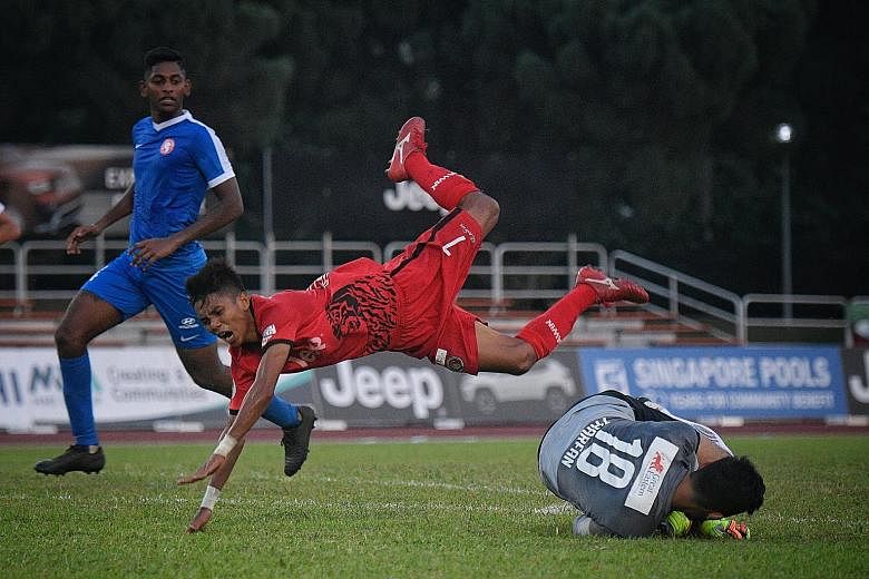 Young Lions goalkeeper Zharfan Rohaizad saving from Balestier's Hazzuwan Halim yesterday. The Tigers remain sixth in the SPL.