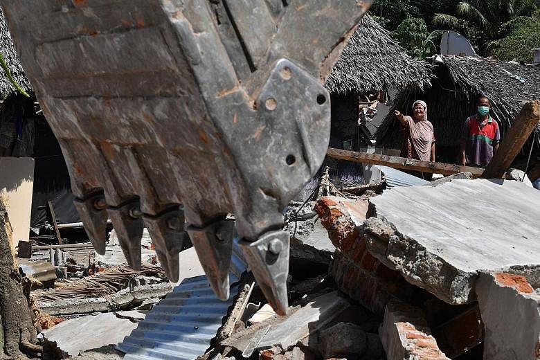 A house in the Gangga area being destroyed yesterday for security reasons, after two deadly tremors hit the Indonesian island of Lombok in recent weeks, killing nearly 400 people. The earthquakes struck during the crucial tourism season, when hotels,