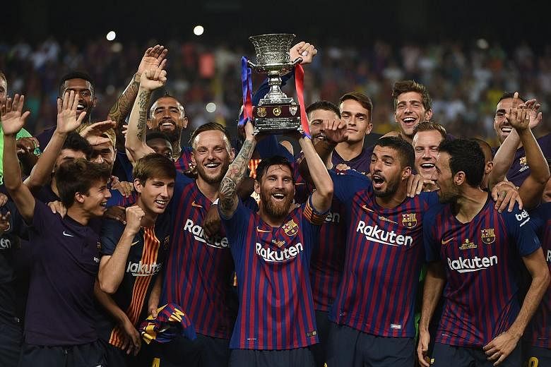 Barcelona captain Lionel Messi lifting the Spanish Super Cup after they came from behind to beat Sevilla 2-1 at the Ibn Batouta Stadium in the Moroccan city of Tangier.