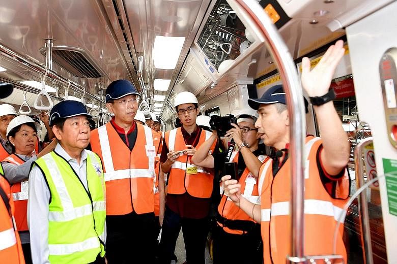 Transport Minister Khaw Boon Wan (far left) and new SMRT chief executive officer Neo Kian Hong (beside him) at the pre-launch of the new trains at Bishan depot yesterday.
