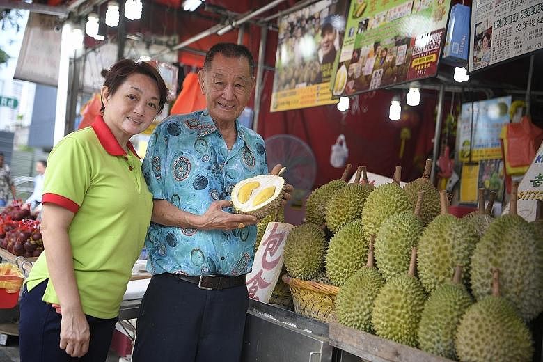 Mr Ang Seck Puan, the boss of Combat Durian, with his daughter Linda at their Balestier stall. Mr Ang is known to durian-lovers for coining catchy durian names such as Sultan Durian, and King Of Kings or Wang Zhong Wang.