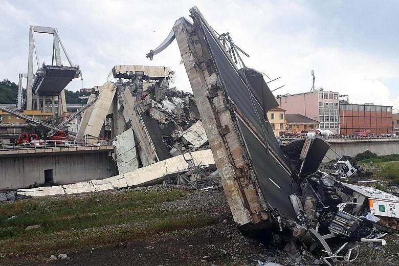 Rescuers at work amid the rubble after a large section of a motorway bridge collapsed during a rainstorm yesterday in the northern Italian city of Genoa. Sky Italia television said four people had been pulled from the rubble.