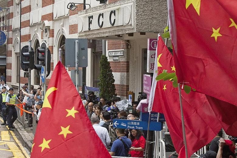 Pro-China supporters gathering outside the Foreign Correspondents' Club (FCC) in Central, Hong Kong, yesterday to protest against a talk by activist Andy Chan to advocate independence. Both Mr Chan and the FCC had faced intense pressure from the auth
