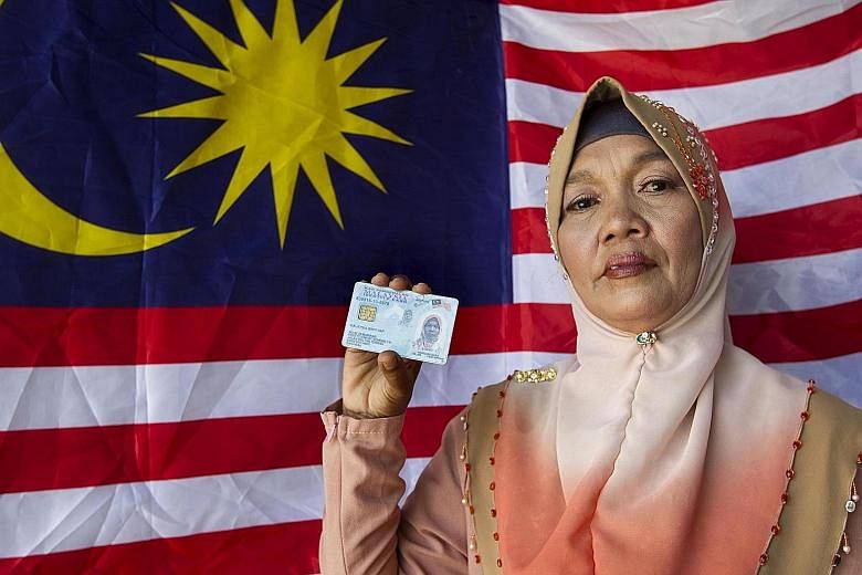 Ms Malaysia Yap holding her Malaysian identity card, which shows her name. She was born in Sarawak on Sept 16, 1963, the day the Federation of Malaysia was formed. Her grandmother named her in honour of the historic Malaysia Day.