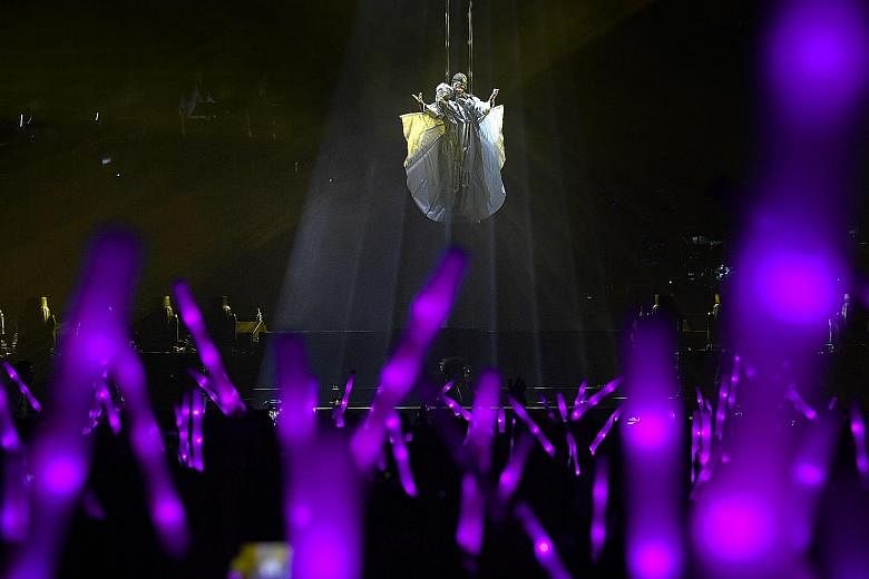 Home-grown Mandopop star JJ Lin made a dramatic entrance for his JJ Lin Sanctuary World Tour at the Singapore Indoor Stadium last night. 	Before an audience of 8,000, he appeared suspended in mid-air, cocooned in white and spinning head over heels sl