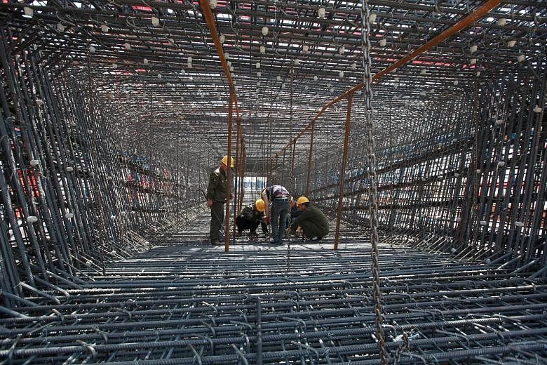 Workers at the construction site of a high-speed railway in eastern Shandong province. Beijing is accelerating infrastructure spending and rolling out other support measures for businesses to cushion the economy as it braces itself for the impact of 