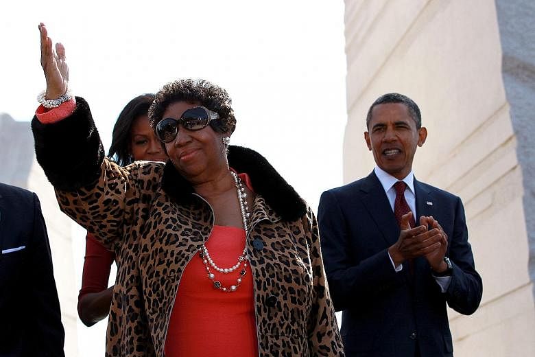 Aretha Franklin with then President Barack Obama and his wife Michelle Obama at the dedication of the Martin Luther King Jr. Memorial in Washington on Oct 16, 2011.