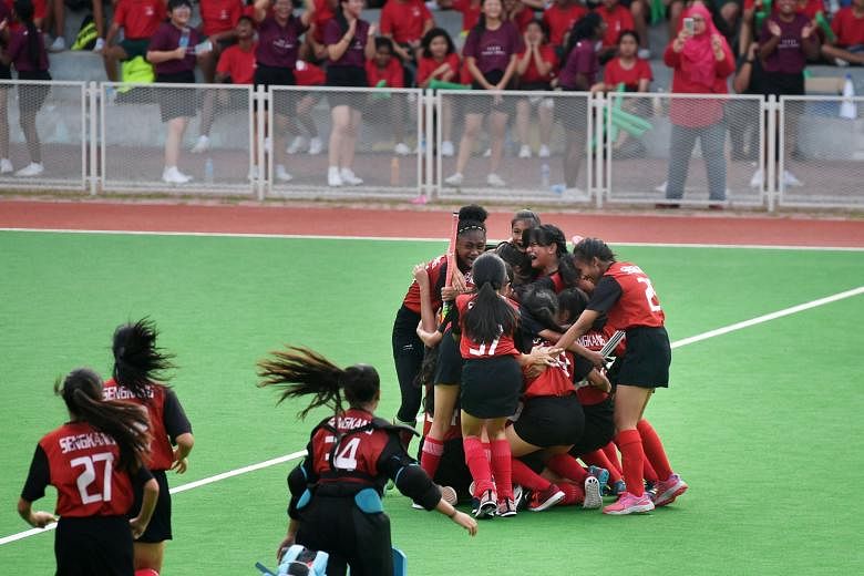 Delighted Victoria School players after their second goal against Seng Kang Secondary School. Defending champions Victoria won the C boys' hockey final 3-2 at Sengkang Hockey Stadium. Seng Kang celebrating winning the C girls' final after beating Cre