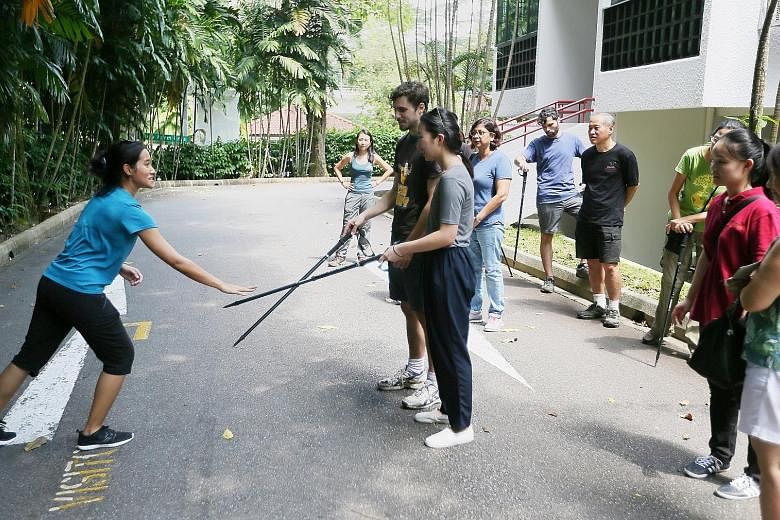 Ms Sabrina Jabbar, a primate researcher at the Jane Goodall Institute Singapore, training volunteers to become monkey guards at Dairy Farm Estate.